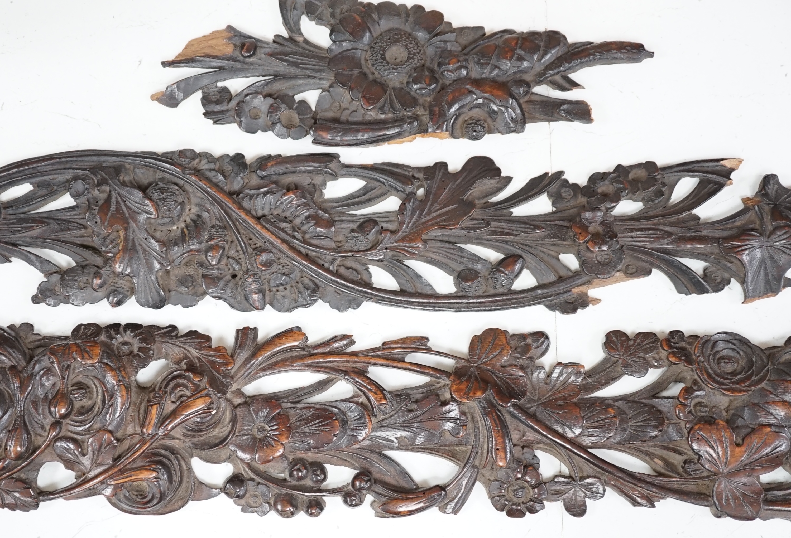 A carved walnut frieze and section with floral decoration, 131cm long. Condition - poor to fair, broken into sections and some woodworm